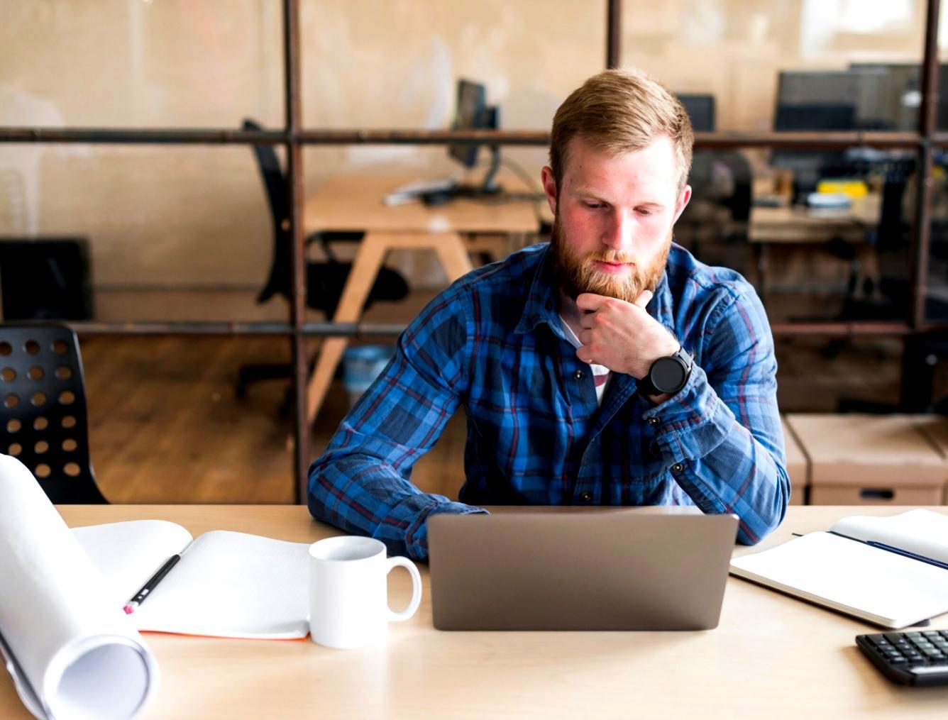 Person reviewing financial documents and planning budget at desk